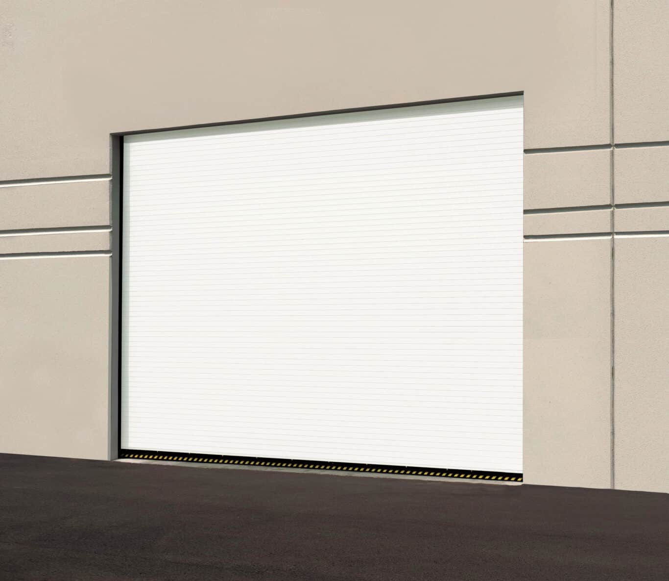 A sturdy white industrial garage door on a beige building, highlighted by a black-and-yellow caution strip at the base. Perfect for anyone looking into garage door replacement options.